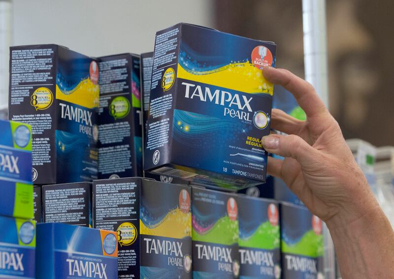 In this June 22, 2016, file photo, Tammy Compton restocks tampons at Compton’s Market, in Sacramento, Calif. Scotland has become the first country in the world to provide free period products.