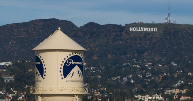 The Paramount Pictures water tower is seen in Los Angeles, Thursday, Dec. 18, 2025, with the Hollywood sign in the distance.