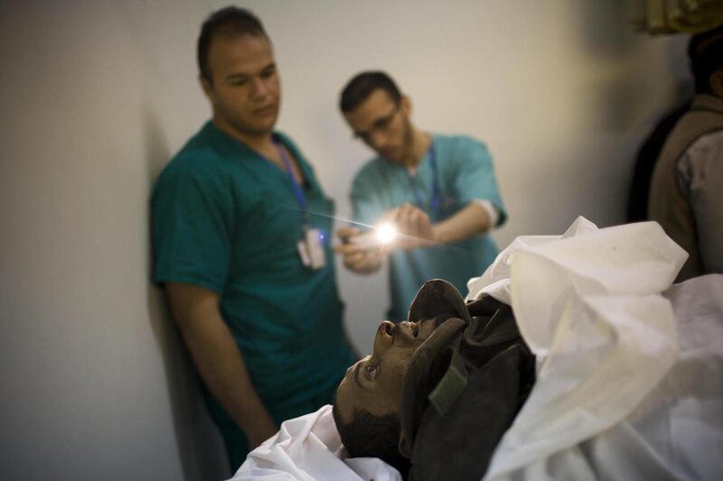 Doctors take a snapshot with a cell phone of the body of a Libyan rebel fighter at Hikma hospital in Misrata, Libya, Thursday, April 28, 2011.