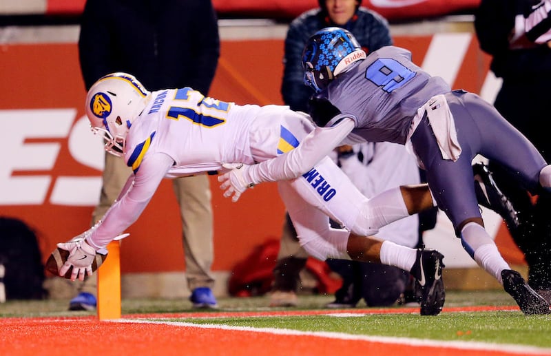 Orem's Puka Nacua dives for the end zone with Sky View's Caleb Christensen defending as they play in 4A semifinal football action at Rice Eccles stadium at the University of Utah on Friday, Nov. 10, 2017. Orem won 28-12.