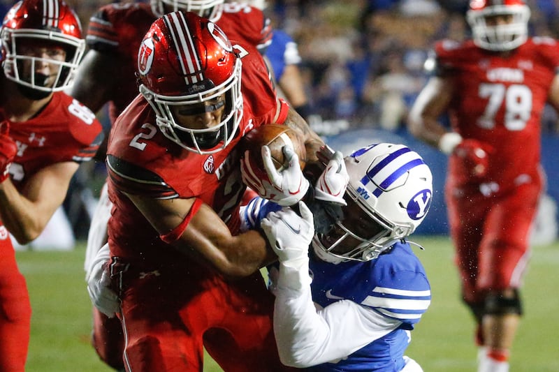 Utah running back Micah Bernard gets tackled by BYU’s defense during game at LaVell Edwards Stadium on Sept. 11, 2021.