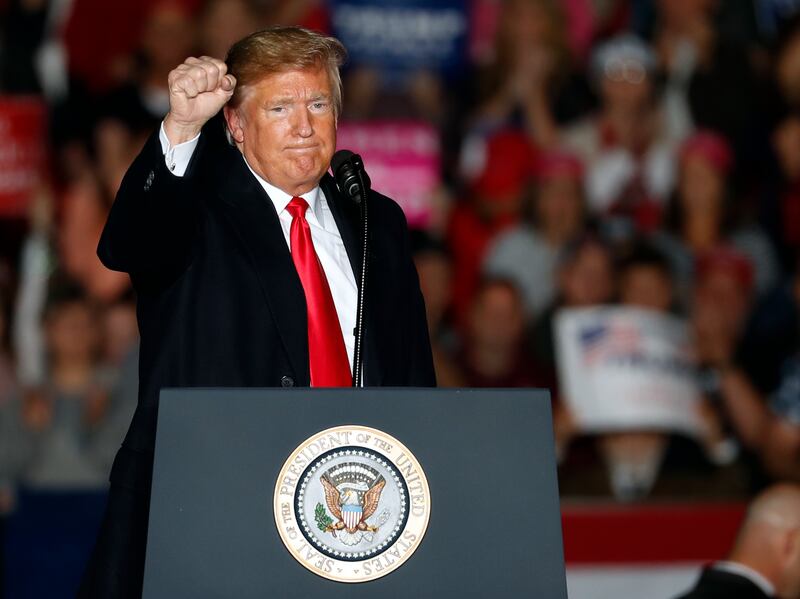 President Donald Trump pumps his fist as he leaves the stage after speaking to supporters during a rally at Southern Illinois Airport on Saturday, Oct. 27, 2018, in Murphysboro, Ill.