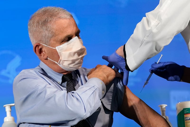 In this Dec. 22, 2020, file photo Dr. Anthony Fauci, director of the National Institute of Allergy and Infectious Diseases, prepares to receive his first dose of the COVID-19 vaccine at the National Institutes of Health in Bethesda, Md.