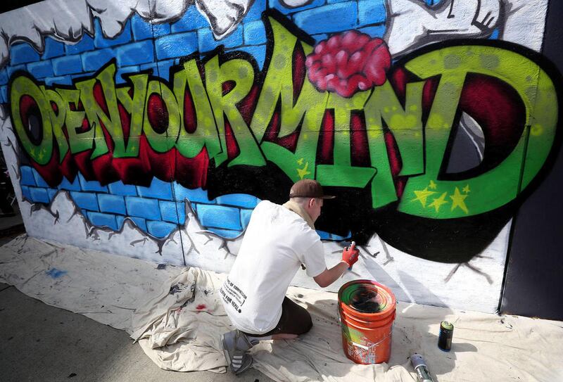 Justin Johnson paints at the Urban Arts Festival at The Gateway in Salt Lake City on Saturday, July 18, 2015.