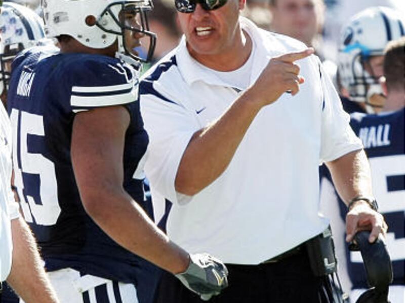 BYU offensive coordinator Robert Anae, right, is excited by the challenge of coaching many young players in 2010.