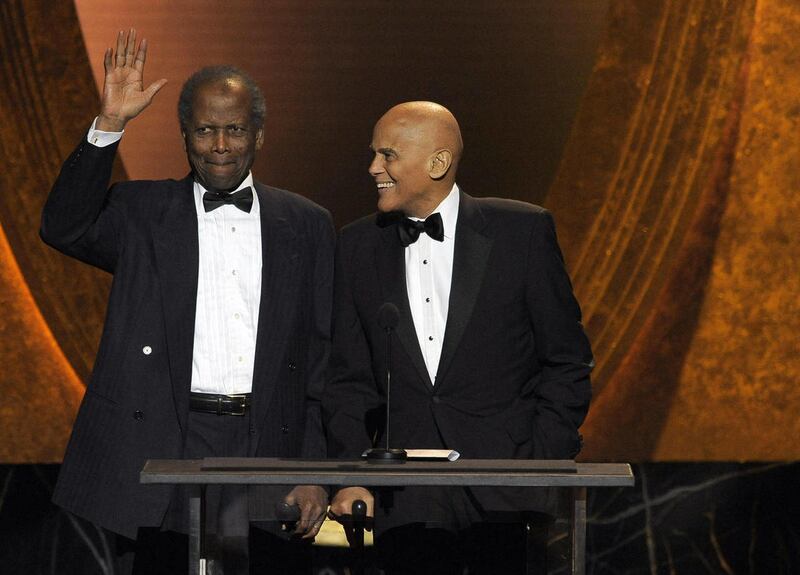 Sidney Poitier, left, and Harry Belafonte speak onstage at the 43rd NAACP Image Awards on Friday, Feb. 17, 2012, in Los Angeles.