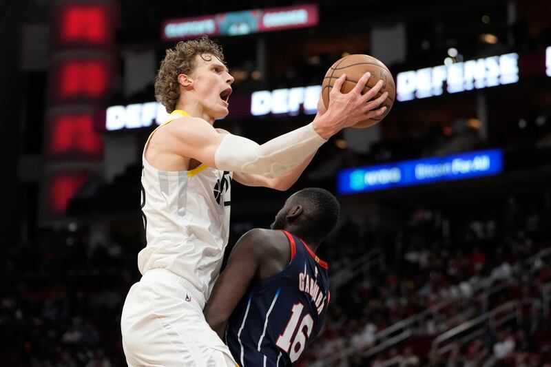 Utah Jazz’s Lauri Markkanen, left, goes up for a shot as Houston Rockets’ Usman Garuba (16) defends during the second half of an NBA basketball game Thursday, Jan. 5, 2023, in Houston. The Jazz won 131-114. (AP Photo/David J. Phillip)
