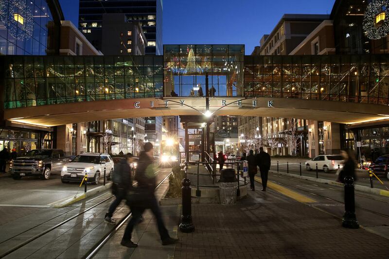 Pedestrians, cars and trains bustle along Main Street in downtown Salt Lake City on Wednesday, Dec. 7, 2016.