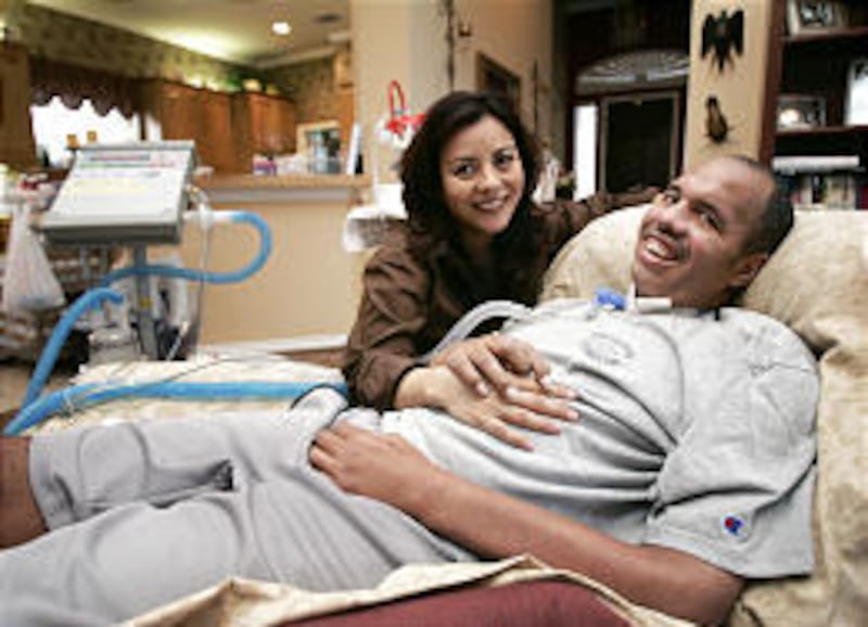Ex-Penn State and NFL fullback Steve Smith poses with his wife, Chie, at his home in Richardson, Texas. Smith, a team captain on the 1986 championship team, suffers from Lou Gehrig's disease.