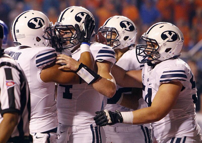 Taysom Hill, second from left, of the Brigham Young Cougars celebrates scoring BYU's only touchdown during NCAA football in Boise, Thursday, Sept. 20, 2012.