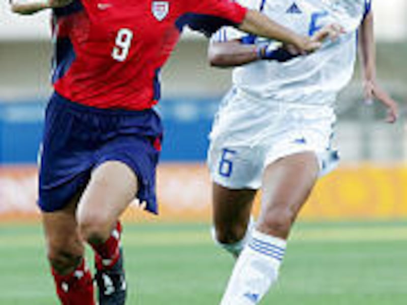 Greece's Eftichia Michailidou, right, fights for the ball with USA's Mia Hamm during a women's Group G preliminary soccer match Wednesday.