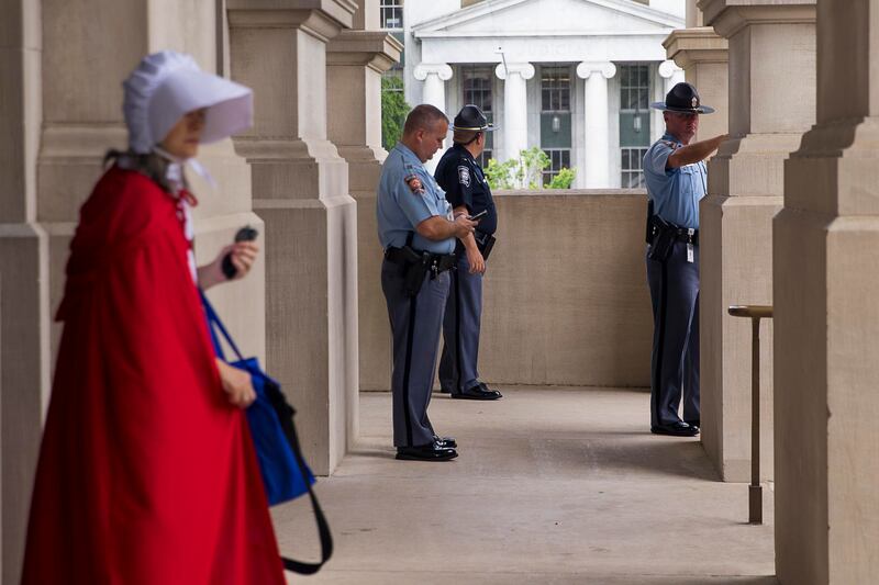 Georgia state troopers keep watch as a crowd of anti-abortion protesters rally outside of the Georgia state Capitol building following the signing of HB 481 in Atlanta, Tuesday, May 7, 2019. Georgia Gov. Brian Kemp signed legislation on Tuesday banning ab