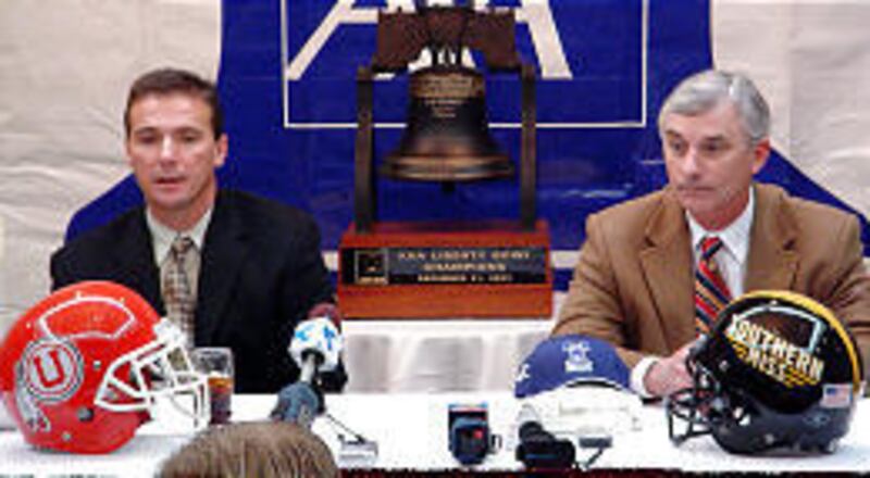 Urban Meyer, left, University of Utah head coach and Jeff Bower, head coach at Southern Mississippi, field questions at press conference.