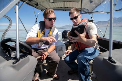 Trevor Gruwell and Ryan Parker, water quality technicians for the Utah Division of Water Quality, plot a course during a sampling mission at Utah Lake in Provo to assess the algal bloom situation on Monday, July 2, 2018.