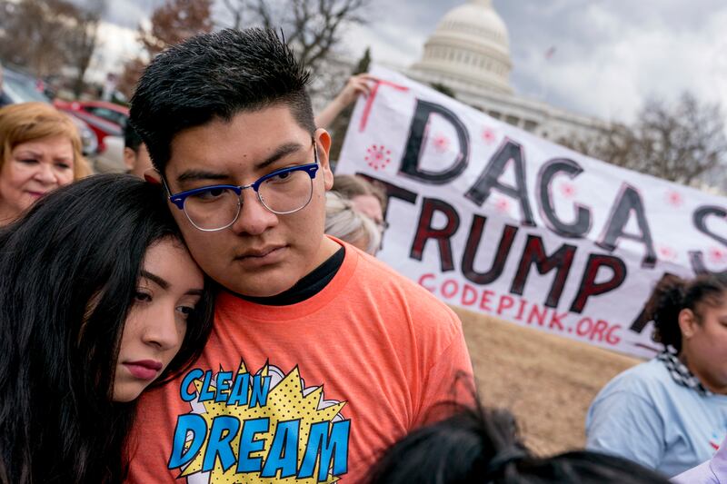 FILE - In this Jan. 23, 2018, file photo, immigration advocates hold a rally on Capitol Hill in Washington. The Obama-era program that shields young immigrants from deportation and that President Donald Trump has sought to end seems likely to survive for
