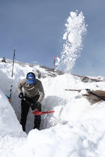 Scott McIntosh, an emergency physician at the University of Utah, digs a hole in the snow for an experiment on the effectiveness of the Black Diamond JetForce air bag at the Utah Olympic Park in Park City on Monday, March 11, 2019. The air bag creates an