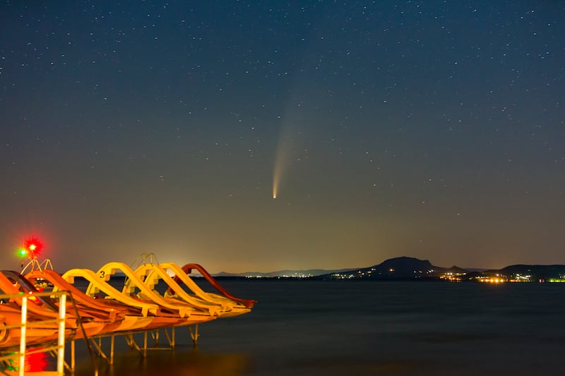 The Comet Neowise or C/2020 F3 is seen before sunrise over Balatonmariafurdo, Hungary, Tuesday, July 14, 2020. It passed closest to the Sun on July 3 and its closest approach to Earth will occur on July 23, 2020.