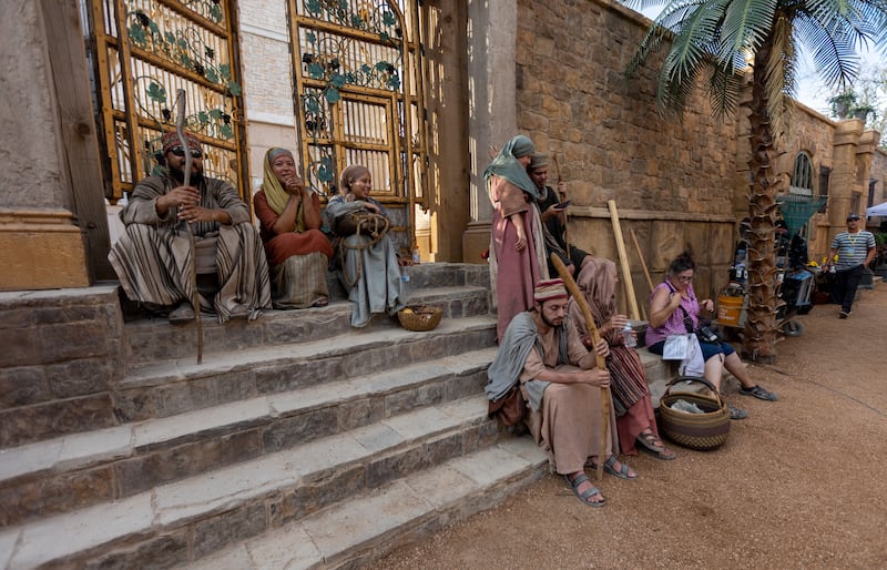 Extras and crew members wait on set to film a scene for Season 3 of “The Chosen” Season 3.