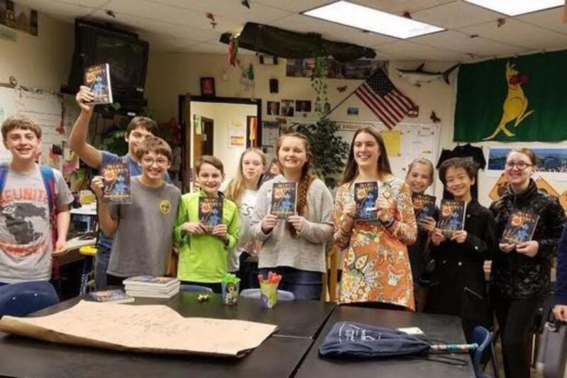 Emily Rose Ross, center in gray shirt, author of "Blue's Prophecy," speaks at the Dodgen Middle School Young Authors' Club in April. The visit was arranged by one of her superfans who found Emily and her book through social media. Photo by Diane Lore.