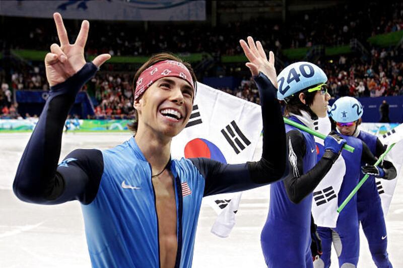 Apolo Anton Ohno holds up eight fingers Friday night after the men's 5,000 relay to signify he'd won his eighth Olympic medal.