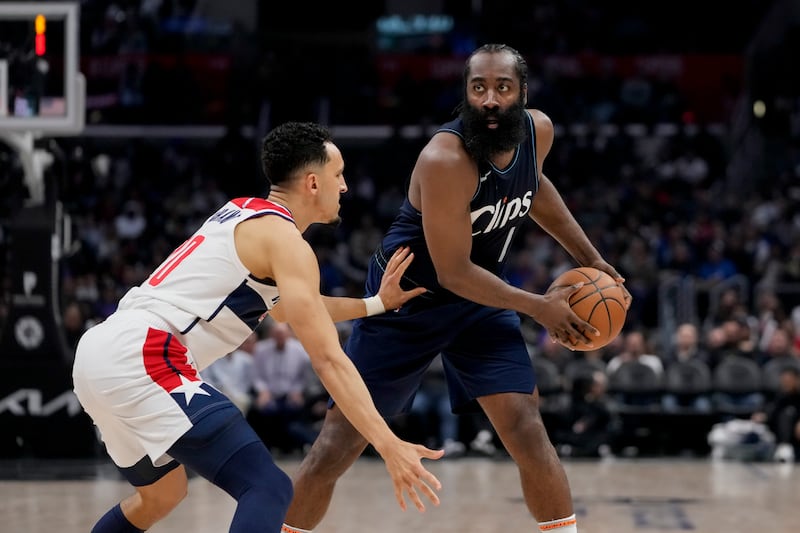 Los Angeles Clippers guard James Harden, right, looks past Washington Wizards guard Landry Shamet.