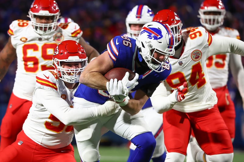 Buffalo Bills tight end Dalton Kincaid (86) carries the ball against Kansas City Chiefs defensive end George Karlaftis (56) during the first quarter of an NFL AFC division playoff football game, Sunday, Jan. 21, 2024, in Orchard Park, N.Y.
