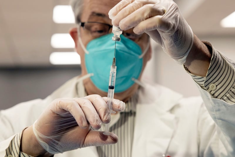 In this Jan. 15, 2021, file photo, CVS Pharmacist Gerard Diebner prepares COVID-19 vaccine for nursing home residents at Harlem Center for Nursing and Rehabilitation, in the Harlem neighborhood of New York.