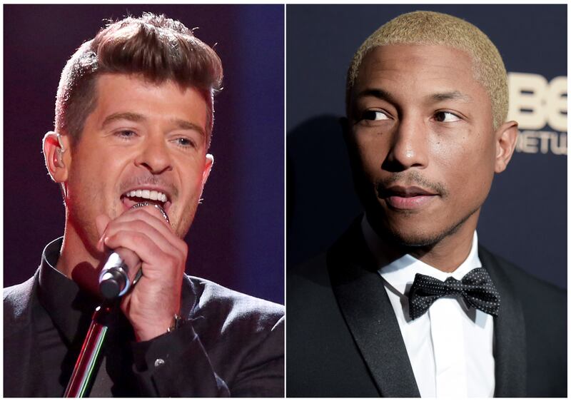 In this combination photo, Robin Thicke performs at the Teen Choice Awards in Los Angeles on Aug. 16, 2015, left, and Pharrell Williams attends the 2016 ABFF Awards: A Celebration of Hollywood in Beverly Hills, Calif., on Feb. 21, 2016. A federal appeals