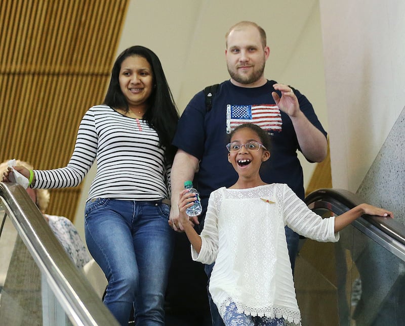 Josh Holt and his wife Thamy and her daughter Marian Leal react as family and friends cheer as they arrive at the International Terminal in Salt Lake City International Airport on Monday, May 28, 2018.