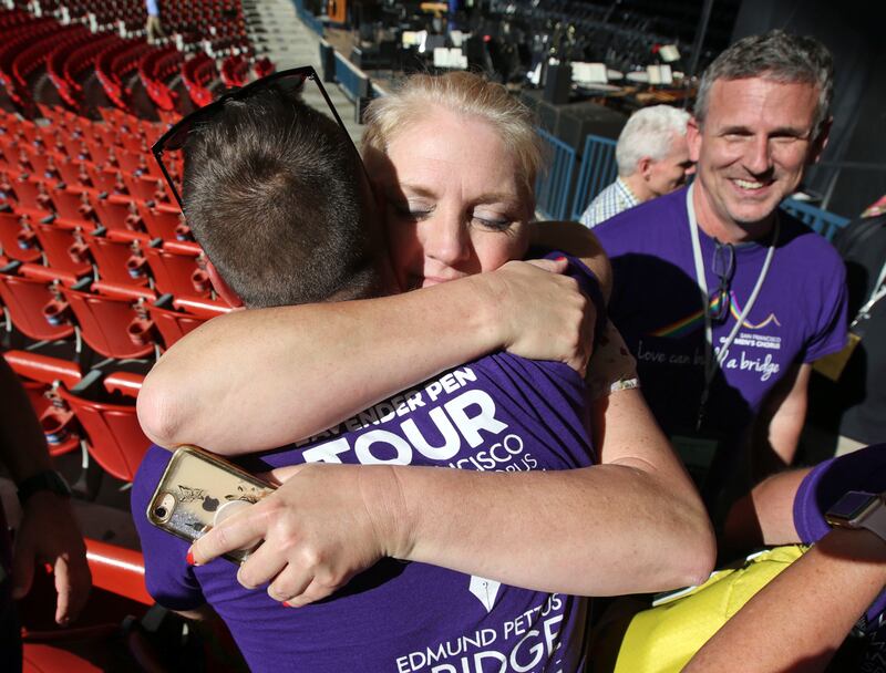 Karen Heath Penman, who has a transgender son, hugs a member of the San Francisco Gay Men's Chorus after soundcheck with the Mormon Tabernacle Choir at the Shoreline Amphitheatre in Mountain View, Calif., on Monday, June 25, 2018.