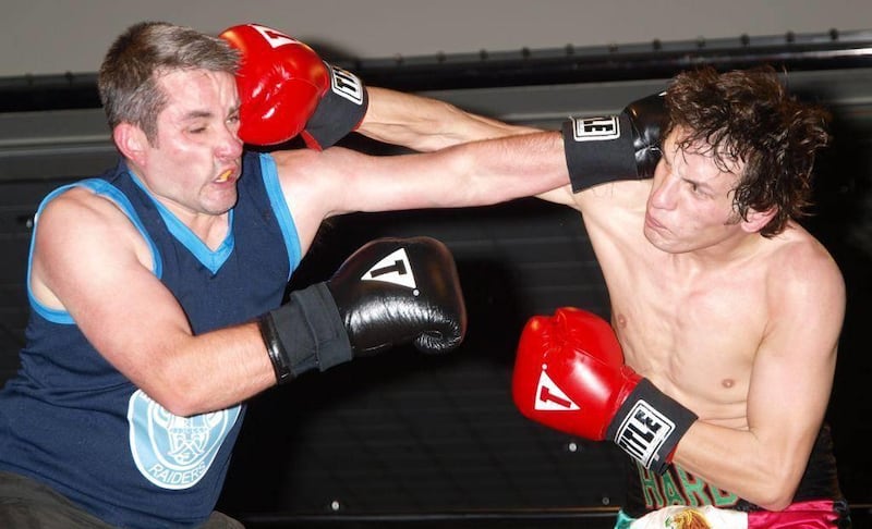 This photo provided by Jim Patton, shows Said Beshirov, left, taking a punch from Kilty Hardy, right, on Feb. 26, 2006 during a boxing match at the Egan Center in Anchorage. Whether it's traditional boxing or mixed martial arts, competitive fighting is