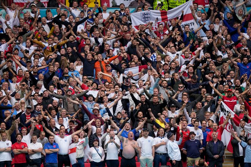 England supporters cheer in the stands before the start of the Euro 2020 soccer championship.