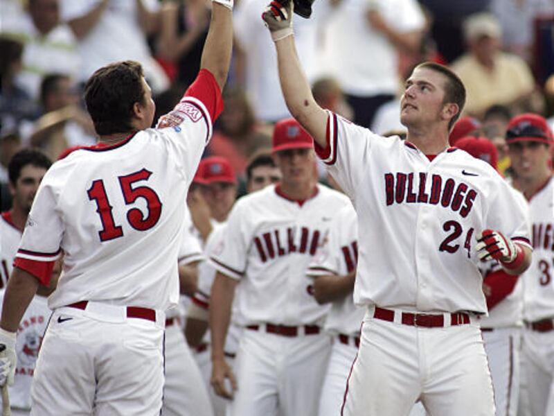 Fresno State's Ryan Overland, right, celebrates with Steve Detwiler after Overland hit a home run against North Carolina in the second inning in NCAA College World Series action on Tuesday.
