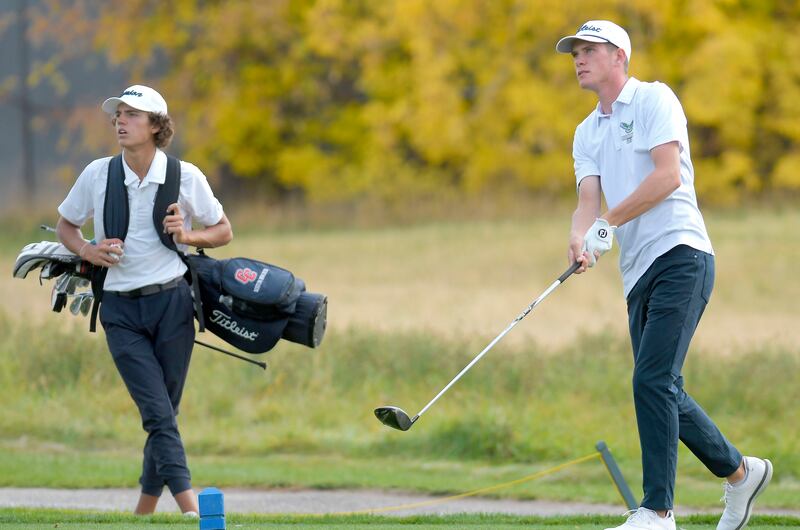 Ridgeline’s Zach Skinner hits his tee shot on the 16th hole as Crimson Cliffs’ Boston Bracken looks on.