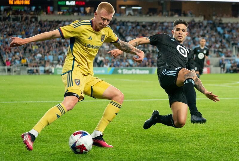 Real Salt Lake defender Justen Glad, left, clears the ball past Minnesota United forward Luis Amarilla, right, in the second half of an MLS soccer match Saturday, May 27, 2023, in St. Paul, Minn. (Alex Kormann/Star Tribune via AP)