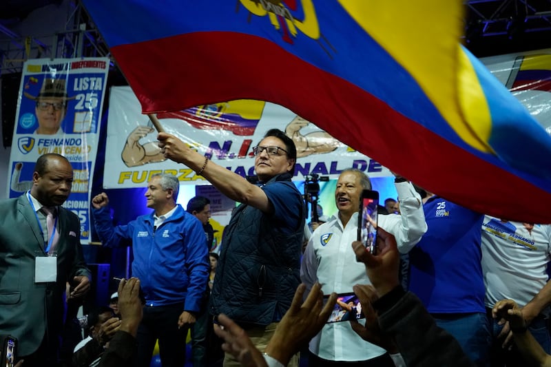 Presidential candidate Fernando Villavicencio waves an Ecuador national flag during a campaign event at a school minutes before he was shot to death outside the same school in Quito, Ecuador.