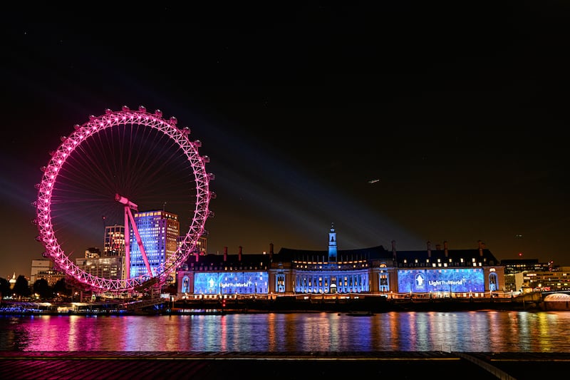 Light the World images illuminate London County Hall next to the London Eye on Wednesday, Nov. 13, 2024.