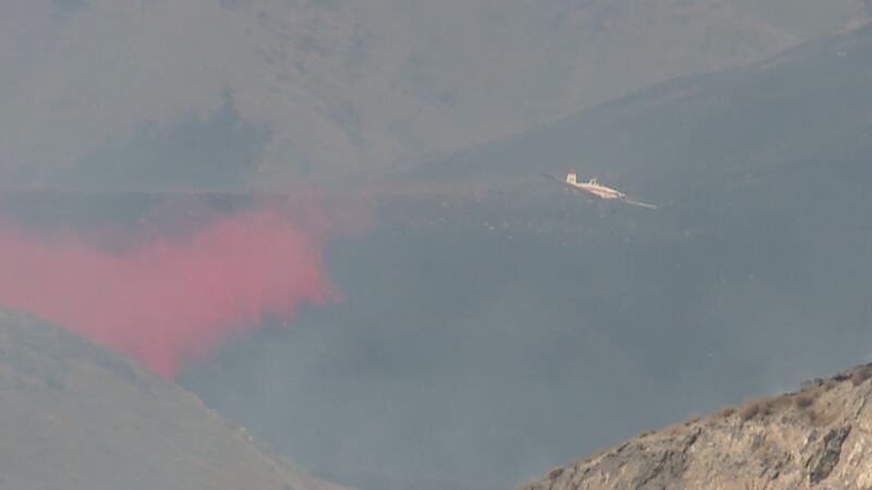 Flame retardant is dropped over the 4,000-acre Ellerbeck fire in remote Tooele County on Tuesday. The blaze was threatening two homes.
