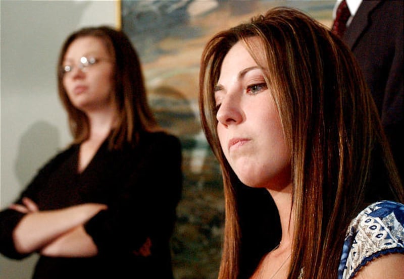 Mary Ann Kingston, right, sits quietly during a 2003 press conference announcing a lawsuit against more than 200 members of the Kingston polygamous clan. Behind Kingston is LuAnn Kingston, a relative who escaped the Kingston order and now assists other Ki