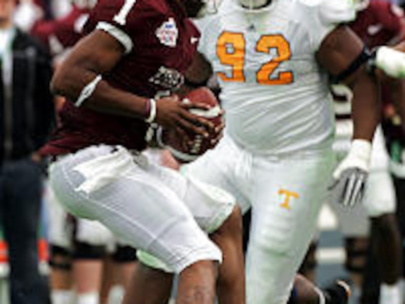 Tennessee tackle Justin Harrell moves in on Texas A&M quarterback Reggie McNeal in Volunteers' blowout Cotton Bowl victory Saturday.