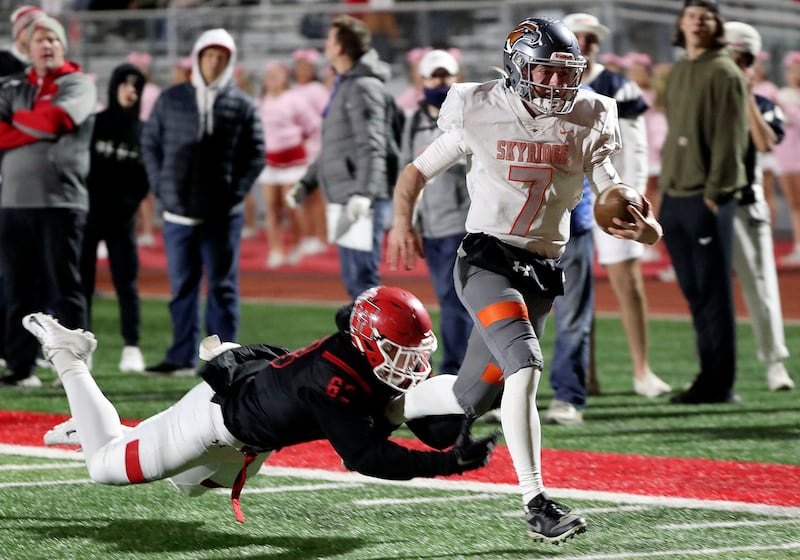 Skyridge’s McCae Hillstead, wearing a white jersey, runs past American Fork’s Hunter Clegg