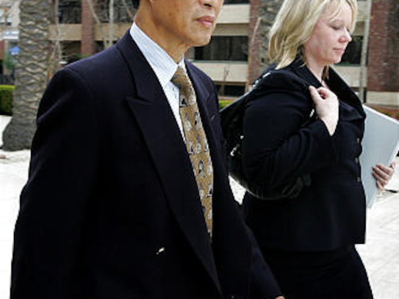Dongfan "Greg" Chung, is shown leaving the U.S. District Court in Santa Ana, Calif., with an unidentified woman.