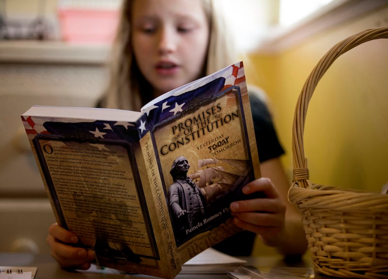 Allison Brown, 8, reads from "Promises Of The Constitution: Yesterday Today Tomorrow" by Pamela Romney Openshaw during home-schooling at her West Jordan home on Friday, Nov. 3, 2017.