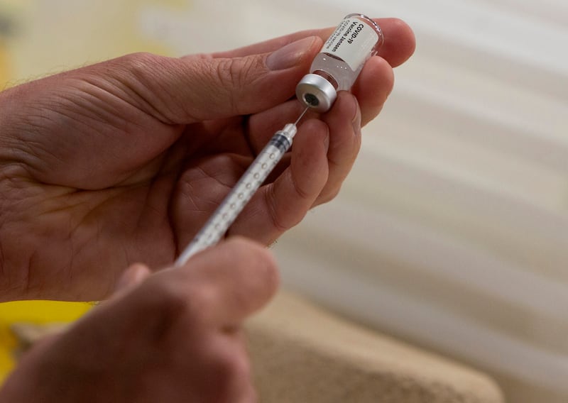 A pharmacist fills a syringe from a vial of the Johnson & Johnson COVID-19 vaccine in Antwerp, Belgium.