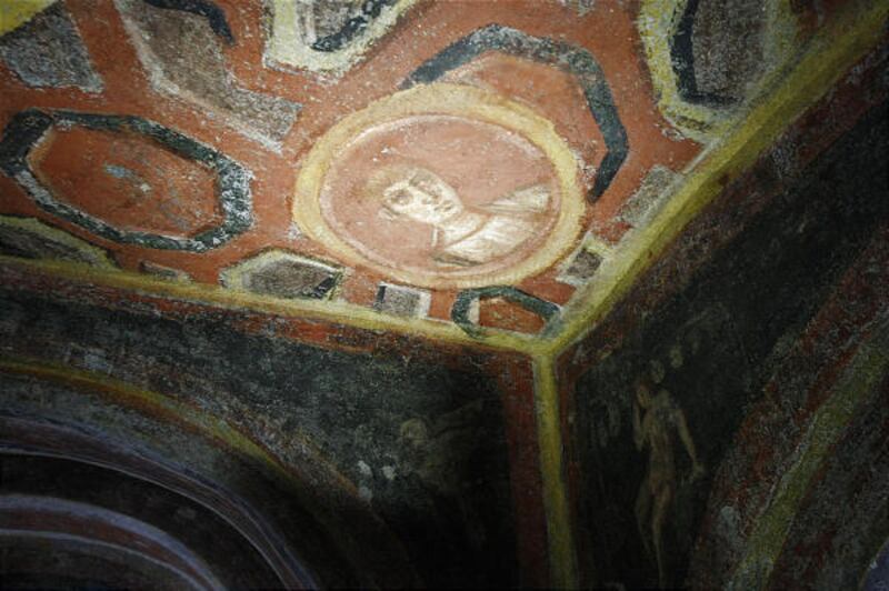 A spotlight illuminates the icon of the Apostle John discovered with other paintings in a catacomb located under a modern office building in a residential neighborhood of Rome.