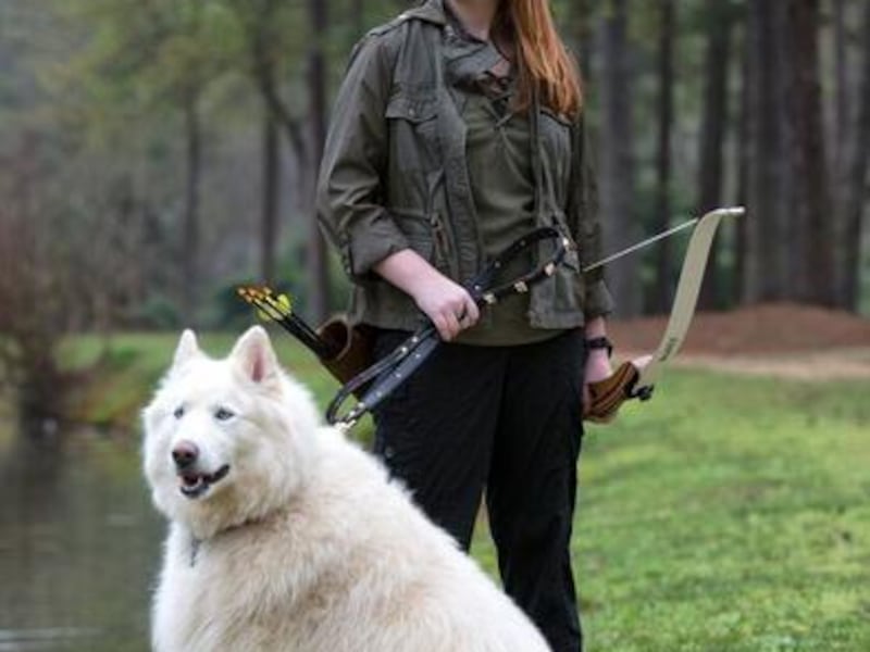 Emily Rose Ross, 15, author of "Blue's Prophecy," poses with her dog, Balta, in East Cobb, Georgia. Emily uses social media to help promote her book and connect with fans. Photo by Billy Howard.