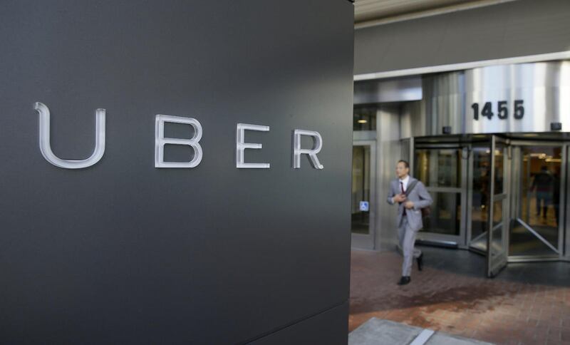 In this photo, a man leaves the headquarters of Uber in San Francisco. In rulings filed Wednesday, March 11, 2015, two San Francisco federal judges said juries will have to decide whether former drivers for Uber and Lyft were independent contractors, or e