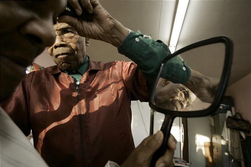 Elvie Lewis gives a haircut to Robert Hunter in his shop in Los Angeles. Business is slowing down for Lewis, who has been cutting hair since 1947.