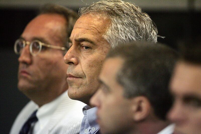 FILE - In this July 30, 2008 file photo, Jeffrey Epstein, center, appears in court in West Palm Beach, Fla.