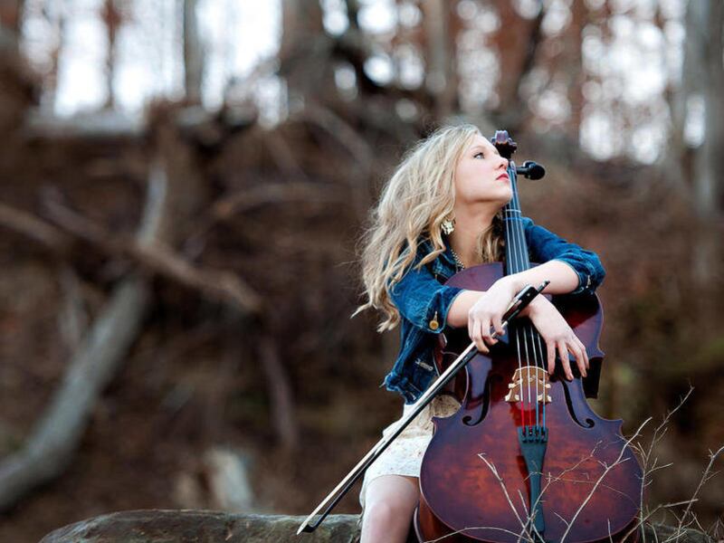 This undated photo provided by the photographer, Michele Coleman, shows a high school senior from Marietta, Ohio, with her arms draped around a cello while perched on an Appalachian hillside. This photo took top prize in a contest sponsored by the Univers